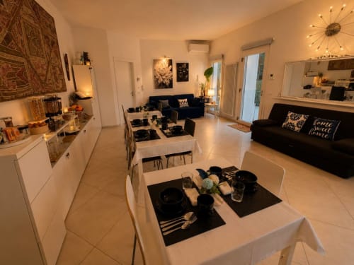 Elegante zona living e pranzo open-plan a Gan Eden B&B a San Benedetto del Querceto con raffinata decorazione bianca e nera