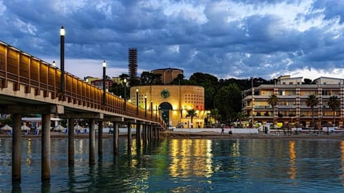 Pescara INN waterfront at dusk with illuminated pier, historic buildings, and sea view in Francavilla al Mare, Italy