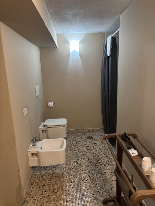 Bathroom at Casale Artemisia B&B in Capalbio with bidet, toilet, and mosaic tile floor