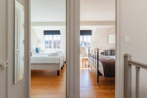 Connected bedrooms at Les Maisons de Pierre et Valérie boutique B&B in Honfleur with wooden floors and bay windows
