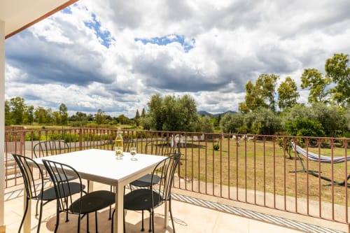 Outdoor dining terrace at Agriturismo Chiai Francesco with mountain views, Bari Sardo