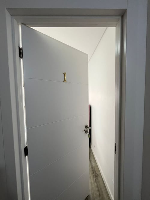White modern door with horizontal panels at Casa Augusta hostel private room C6 in Braga, Portugal