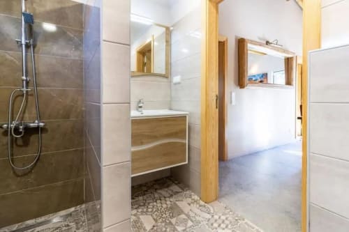 Modern bathroom with walk-in shower, wooden vanity, and tile flooring at Quinta Boa Vida villa in Alcobaça