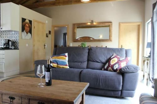 Modern living room with dark blue sofa, wooden coffee table, and wine bottle at Quinta Boa Vida villa in Alcobaça