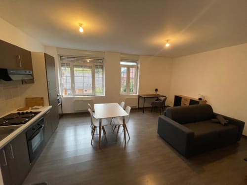 Appartement ouvert à Caudry avec cuisine, table à manger et salon avec vue sur la ville