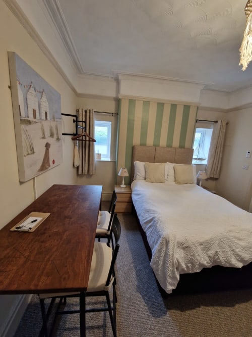 Standard Family Room at Blacksheep Lodge in Holyhead with double bed, desk, green striped wallpaper and two windows