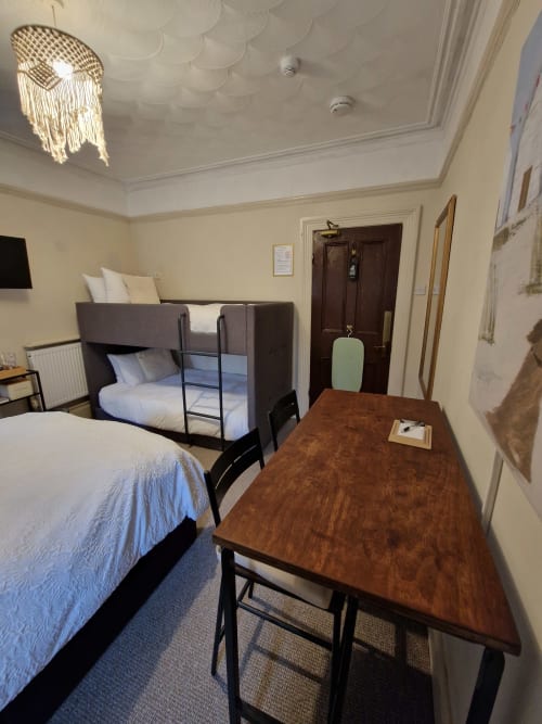 Standard Family Room at Blacksheep Lodge, Holyhead with single bed, bunk bed, desk, and modern ceiling light