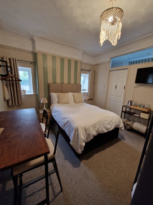 Spacious Standard Family Room at Blacksheep Lodge in Holyhead with queen bed, desk, seating area, and flat-screen TV