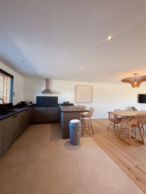 Cuisine ouverte et salle à manger modernes à Villa Benedettu à Porto-Vecchio avec parquets et mobilier contemporain