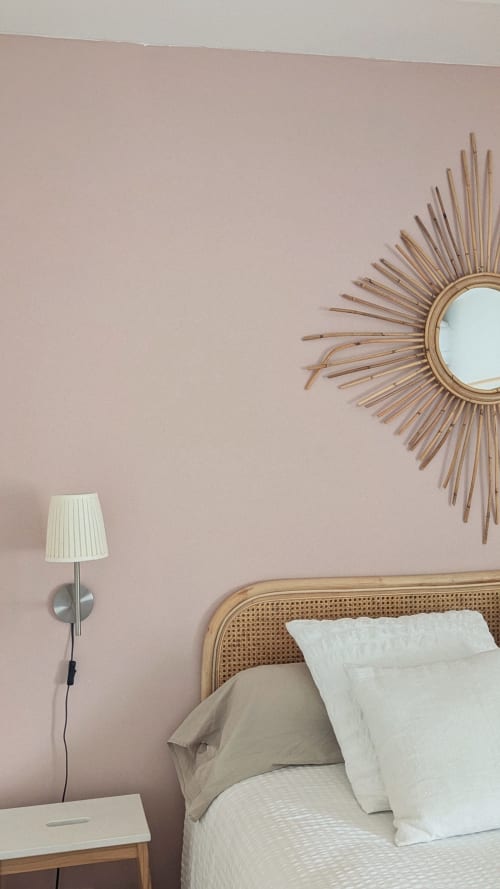 Camera serena a Casa Orma con pareti rosa, specchio sole e testata in rattan a Saint-Ilpize