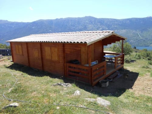 Chalet en bois avec toit métallique aux Chalets de Lozzi à Calacuccia, vue sur le lac et les montagnes