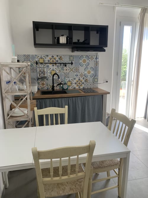 Cucina moderna con rivestimento in piastrelle decorate e zona pranzo presso Ca' Salino BnB a Villa Inferno, Italia