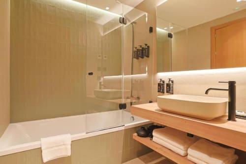 Modern bathroom in Hotel Fonsispa Standard Double Room with glass shower enclosure, wooden vanity, vessel sink, and mountain