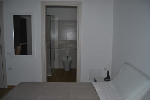 Camera moderna di Makasa BnB a Villapiana con bagno in camera, arredamento minimalista e pavimenti in legno