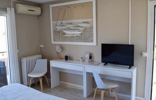 Privilege Double Room at Hôtel l'Orangeraie Lavandou with workspace, flat-screen TV, and sailboat artwork