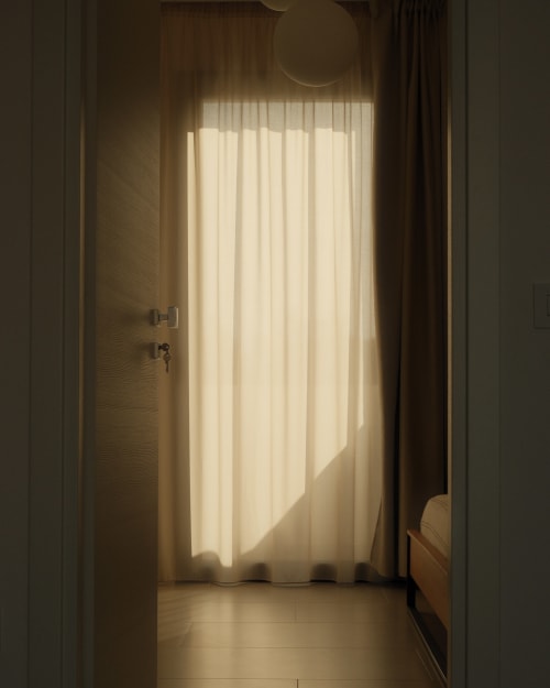 Bright sunlit room at Nafura hotel in Raffadali with sheer curtains filtering natural light onto wooden floor