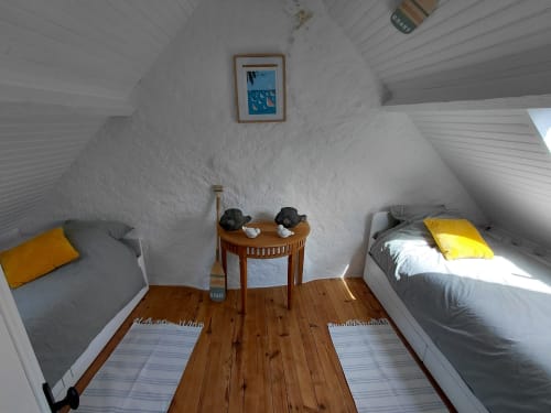 Chambre mansardée cosy du gîte Kergue'ch à Belle Île en Mer avec deux lits, parquet et touches jaunes