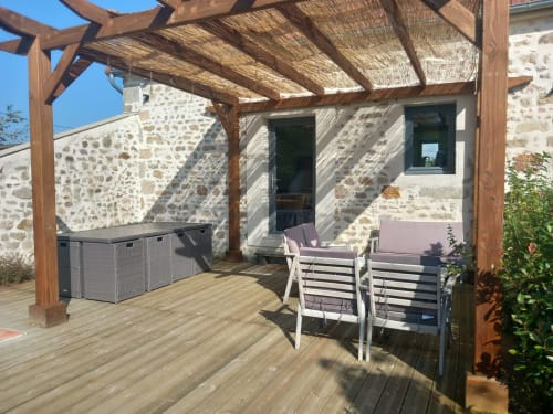 Terrasse ombragée à la villa L'Amandier, La Maison De Fleurat, avec chaises longues et vue sur le jardin à Domeyrot
