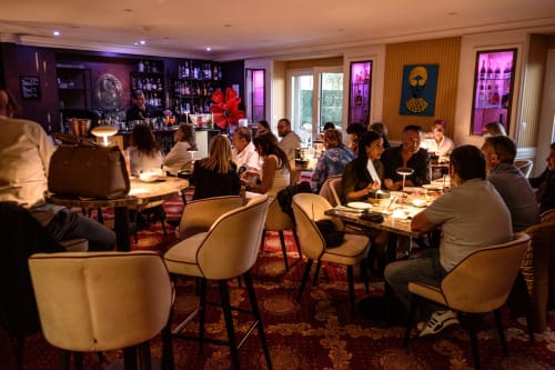 Elegant evening event at Hotel Splendid Cannes with guests dining in modern lounge with purple lighting