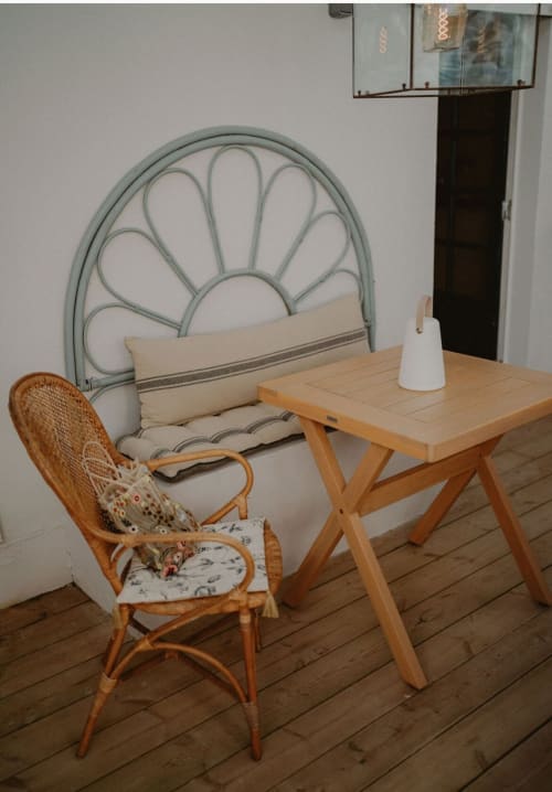 Chambre Suite Bleu Azur au Bleu Guesthouse avec fauteuil en rotin, bureau en bois et tête de lit en forme d'éventail de paon à Saint-François