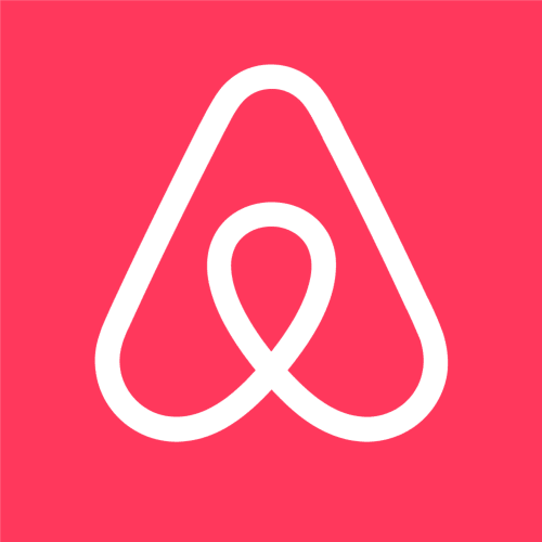 Logo Airbnb blanc sur fond rose pour la maison d'hôtes Bleu Guesthouse en France