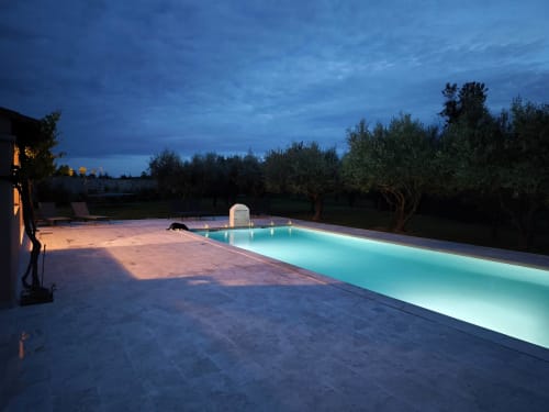 Illuminated pool at dusk, Magnanerie de Sainte Croix hotel in Saint Hippolyte de Caton, France