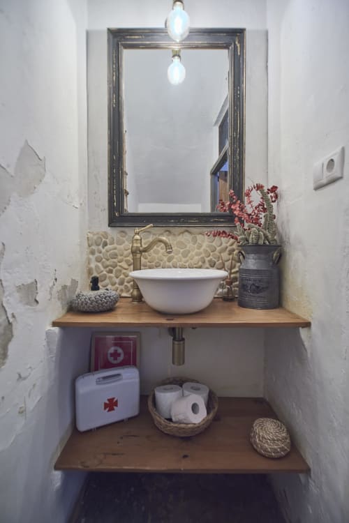 Lavabo rústico en la villa Casas Cercana de Abarán con backsplash de piedra, espejo enmarcado y accesorios decorativos