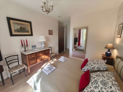 Chambre Perle at Magnanerie de Sainte Croix B&B: elegant bedroom with twin beds, wooden dresser, mirror, and garden views