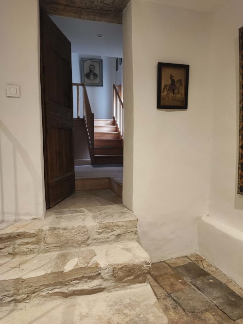 Stone hallway entry to Chambre Perle at Magnanerie de Sainte Croix in Saint Hippolyte de Caton with wooden door and staircase