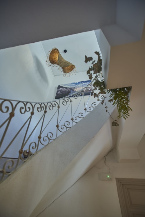 Escalera con barandilla de hierro ornamentado y obra de arte decorativa en la casa rural Casa Cercana de Abarán