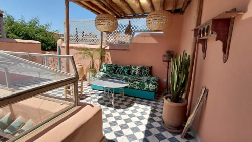 Riad Dar Kleta terrace in Marrakech with turquoise seating, geometric tiles, and Moroccan décor