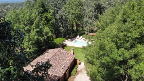 Aerial view of El Escondite De Pedro Malillo B&B in Candeleda with pool, terracotta roof, and surrounding trees