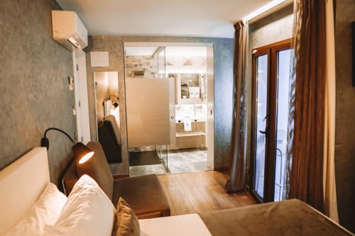 Amplia habitación doble de lujo en Hotel Boutique Mamma Mia Tossa con baño moderno, suelos de madera y ducha de cristal