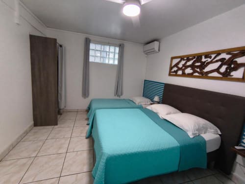 Lits jumeaux avec literie turquoise dans la chambre Alisée à la Résidence B&L Lagon, Sainte-Luce