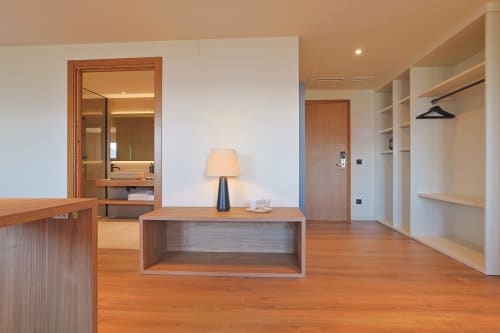 Modern hotel suite at Hotel Fonsispa in Renanué featuring wooden desk, lamp, and walk-in closet with shelving