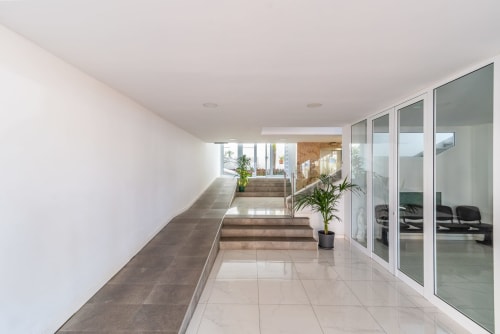 Moderner Flur mit Glastüren, Topfpflanzen und Fliesenböden im M&M Suite Yumbo Atlantis in Maspalomas