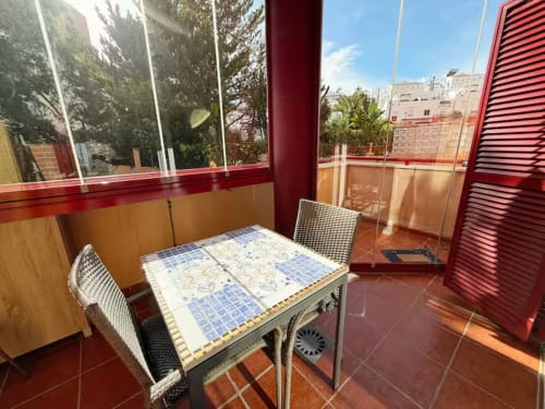 Estudio luminoso en primera línea de playa en Fuengirola con terraza, comedor, vistas a la ciudad y mobiliario moderno