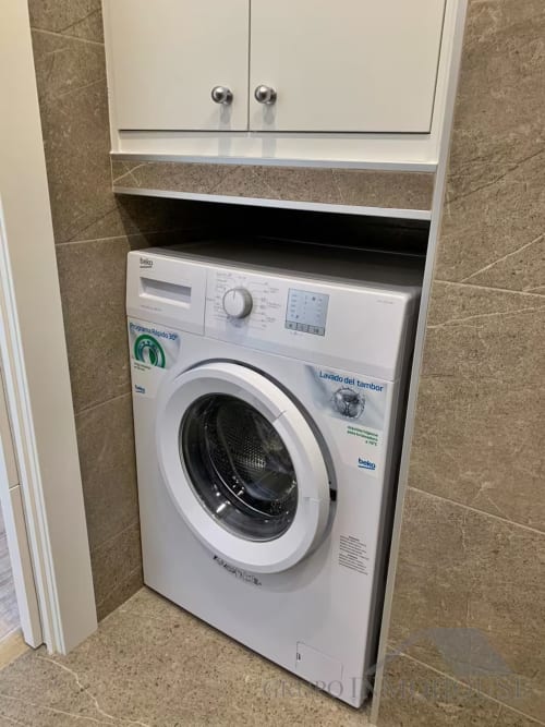 Moderno electrodoméstico Beko en nicho de cuarto de baño de apartamento frente al mar, Fuengirola