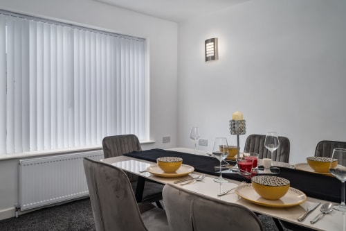 Borrowdale Brook dining area at Leeds Luxurious Stays with elegant table setting and vertical blinds