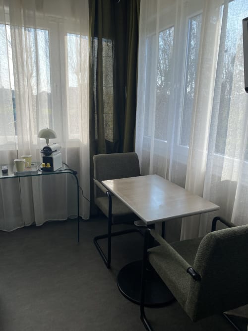 Studio à l'hôtel Cosyade à Bourbourg avec table à manger, vue sur le jardin et mobilier moderne