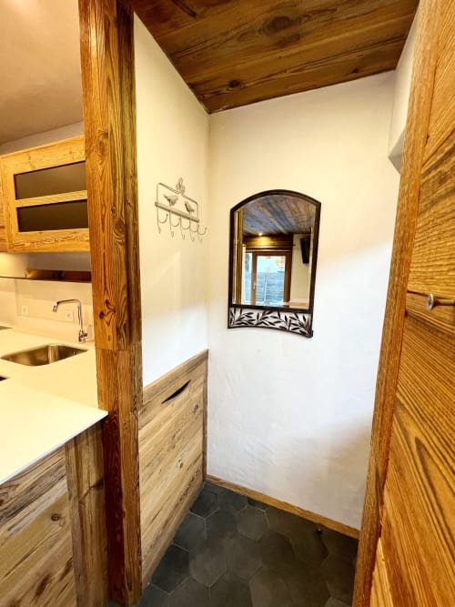 Modern bathroom with wooden vanity, sink, and decorative mirror at Chez Francine apartment in Notre-Dame-de-Bellecombe