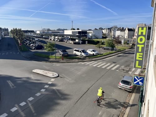 Street view of Hôtel De La Mairie in Saint-Pol-de-Léon with parking area and city surroundings