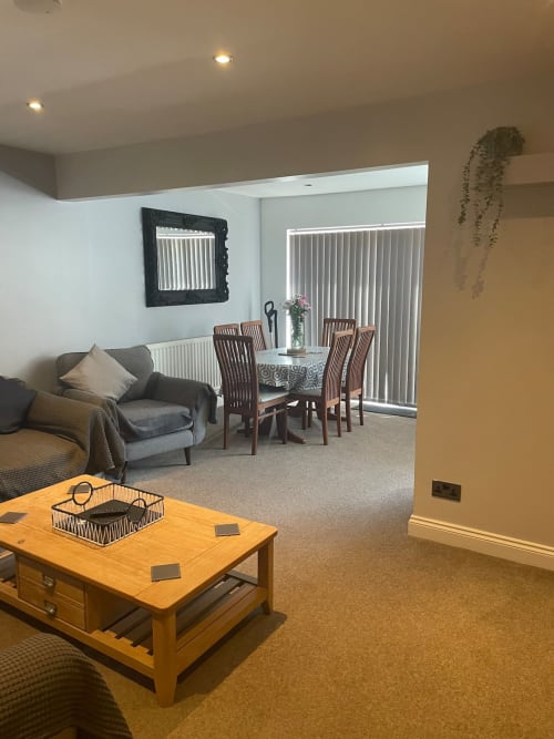 Modern living and dining area at 2 Doves Holiday Property in Exeter with comfortable seating and wooden table