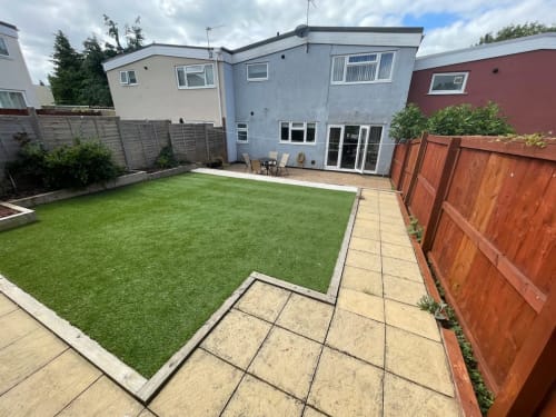 2 Doves Holiday Property backyard in Exeter featuring green lawn, patio area, and wooden fences