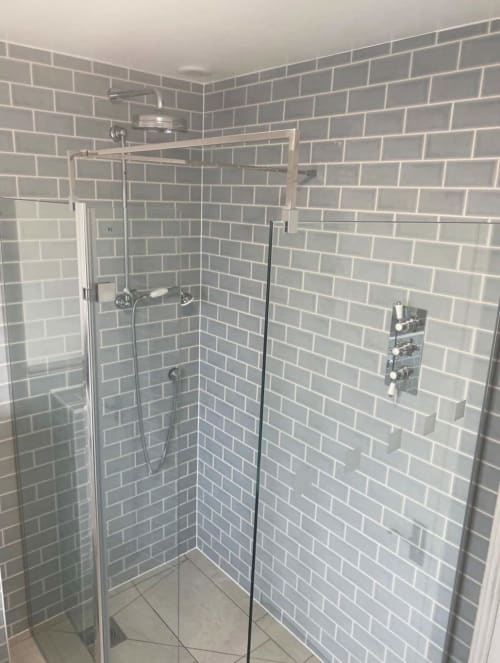 Modern shower enclosure with grey subway tiles at 2 Doves Holiday Property in Exeter