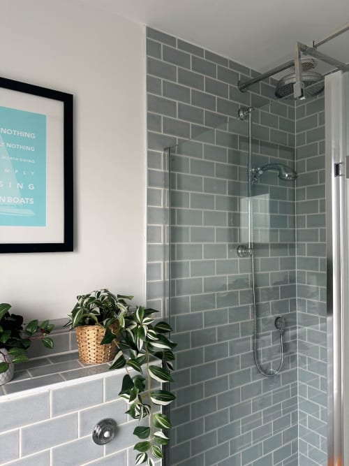 Modern bathroom at 2 Doves Holiday Property, Exeter with gray subway tile shower and green plant decor