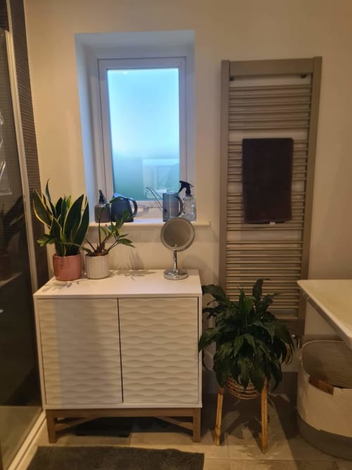 Modern bathroom at 2 Doves Holiday Property in Exeter featuring vanity, plants, and window view