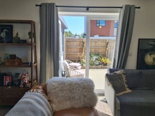 Modern living room at 2 Doves Holiday Property in Exeter with patio doors opening to garden