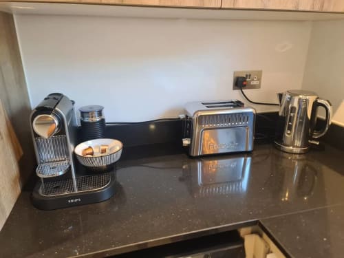 Kitchen counter at 2 Doves Holiday Property, Exeter featuring Krups coffee machine, toaster, kettle and amenities