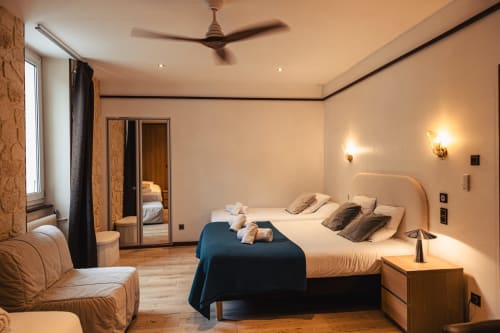 Chambre luxueuse du Savoy Hôtel au Bourget-du-Lac avec lit king-size, équipements modernes et mobilier élégant